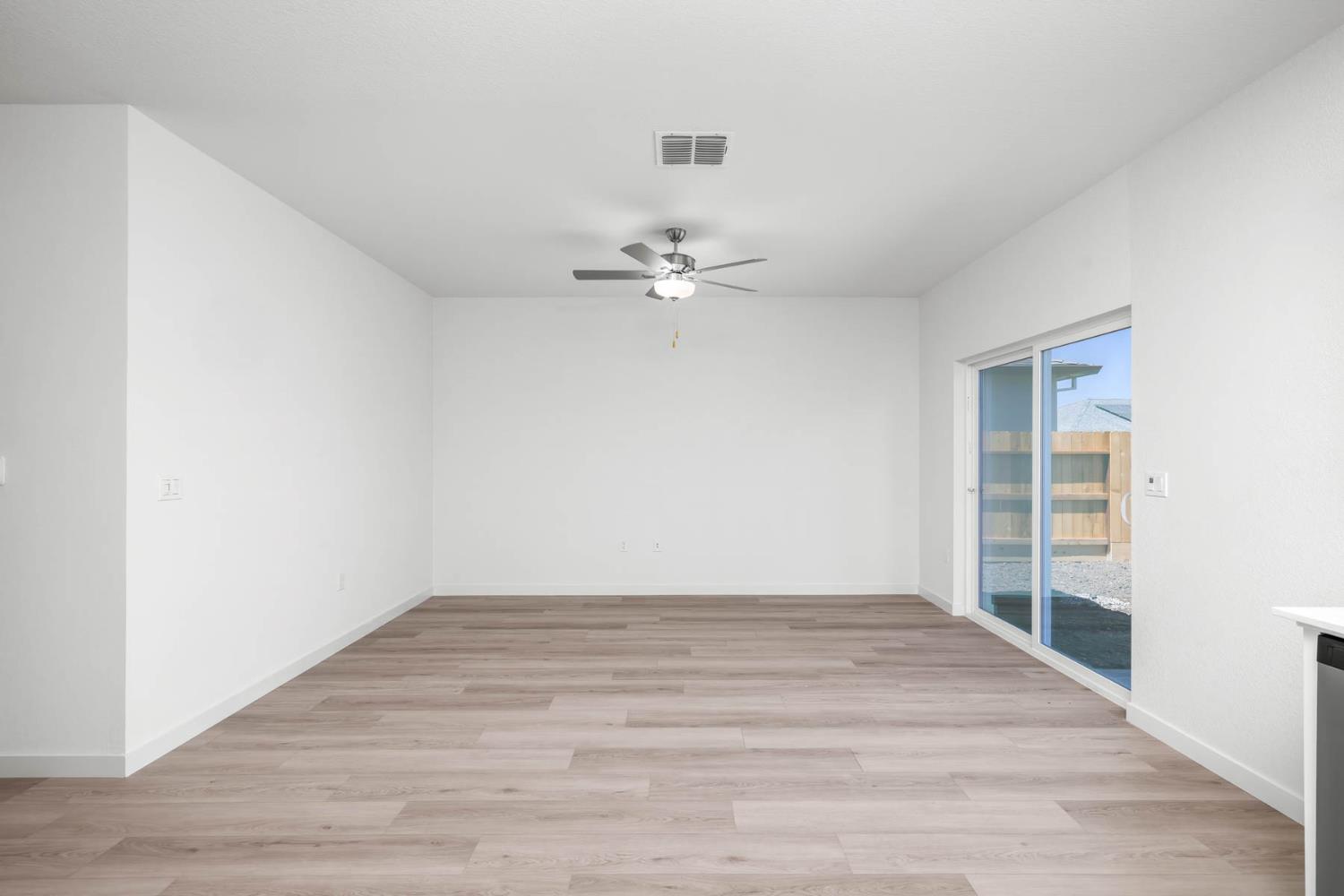 3077 Isley Way Stockton, CA 95212 - Photo 5 of 10 a view of a room with wooden floor and ceiling fan