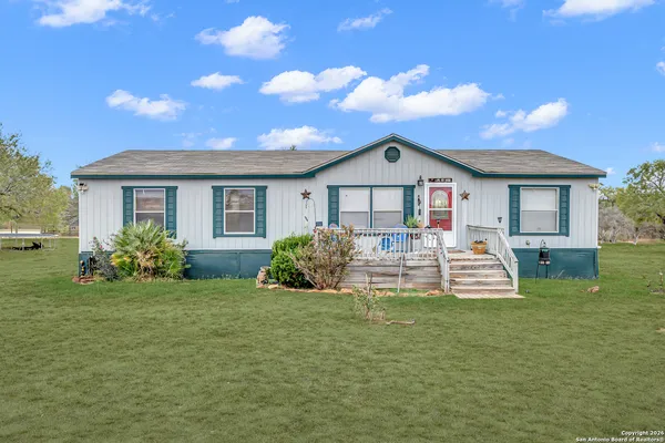 a view of a house with a back yard