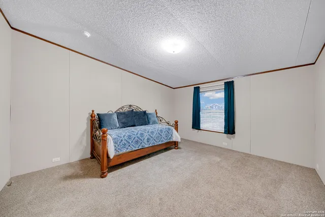 a living room with furniture and a ceiling fan
