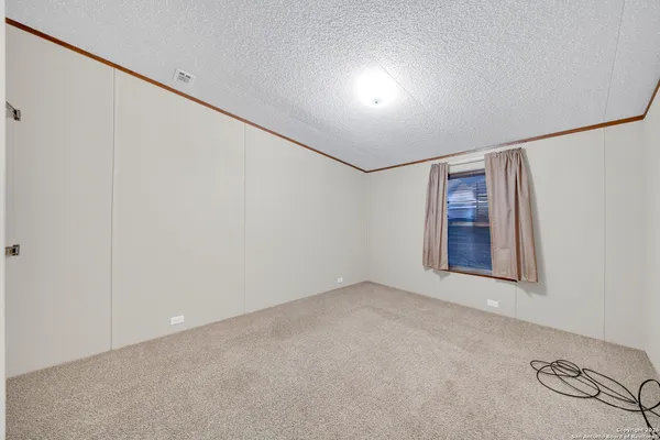 a view of a room with furniture and wooden floor