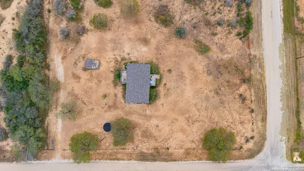 an aerial view of a house with a yard