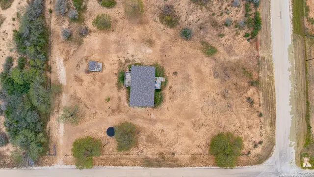 an aerial view of a house with a yard