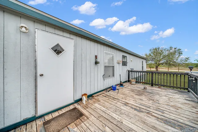 a view of a house with a wooden deck