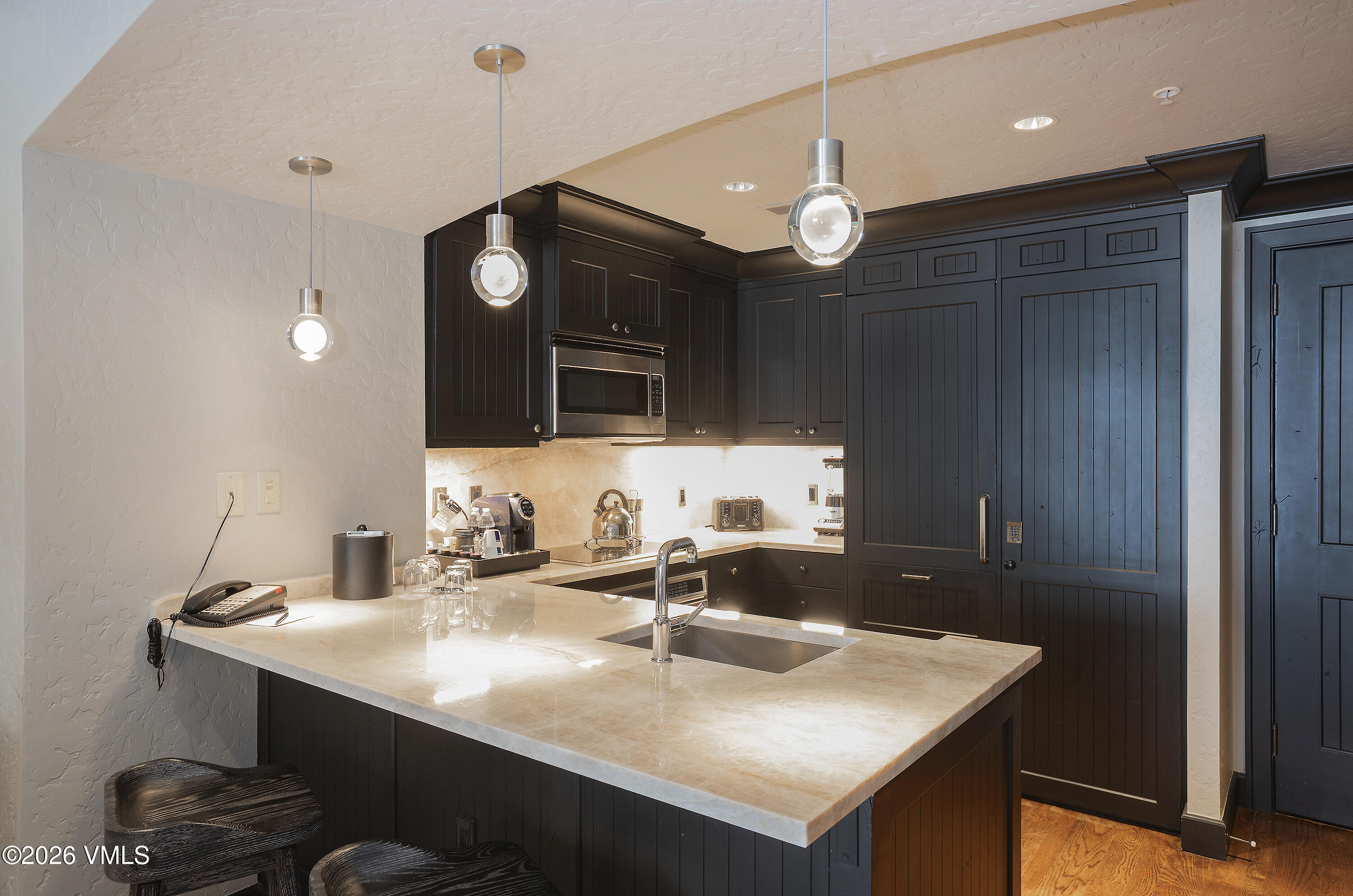 130 Daybreak Ridge Road, Unit HS640 Avon, CO 81620 - Photo 12 of 54 a kitchen with a sink cabinets and wooden floor