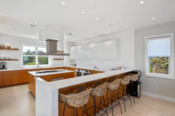 a kitchen with stainless steel appliances granite countertop a sink and a refrigerator