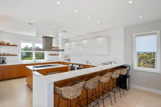a kitchen with stainless steel appliances granite countertop a sink and a refrigerator