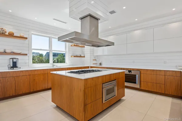 a kitchen with granite countertop a stove sink and cabinets