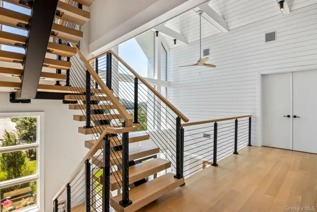 a view of entryway with wooden floor and stairs