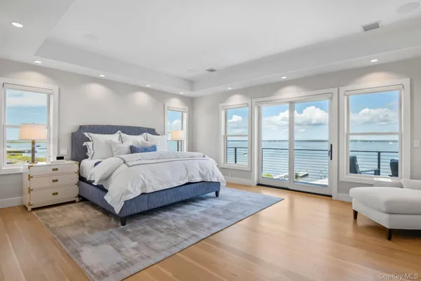a spacious bedroom with a large bed and a large window
