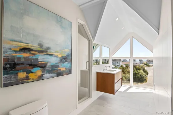 a spacious bedroom with a bed and a large window