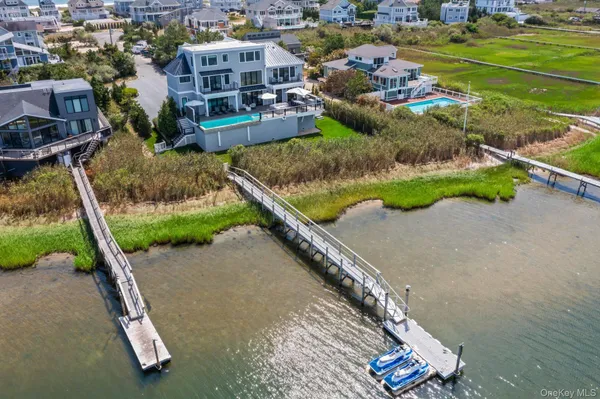 an aerial view of a house with a yard and lake view