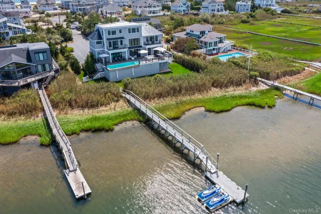 an aerial view of a house with a yard and lake view