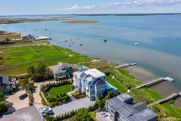 an aerial view of a house with a garden and lake view