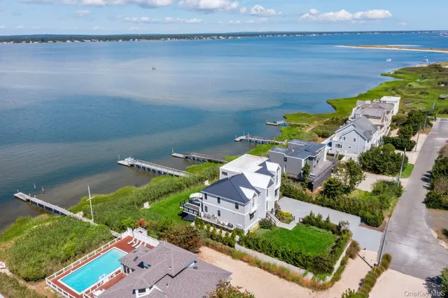 an aerial view of a house with a garden and lake view