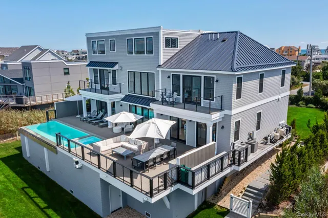 a view of a house with pool and chairs