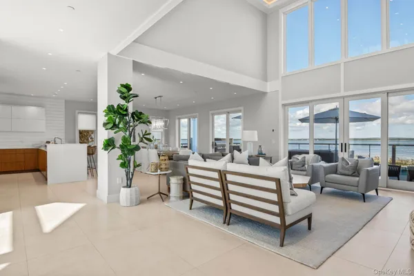 a living room with furniture a fireplace and a floor to ceiling window
