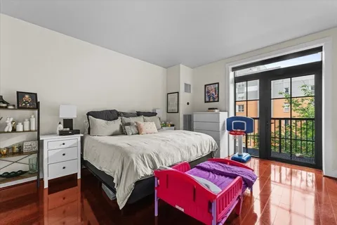 a bedroom with bed and a large window