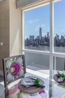 a large white kitchen with a stove a sink dishwasher and a fireplace with wooden floor