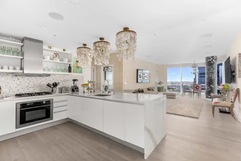 a bedroom with a large bed and a chandelier