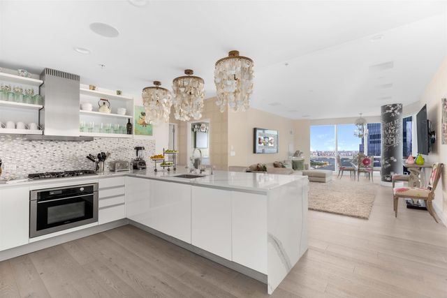 a bedroom with a large bed and a chandelier