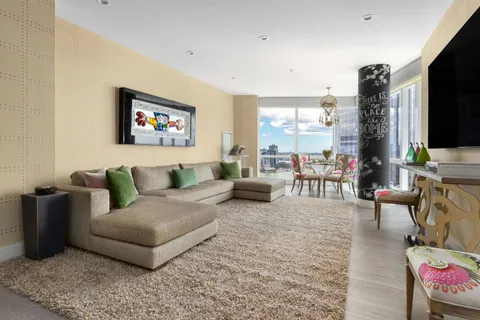 a room with furniture a rug and a book shelf