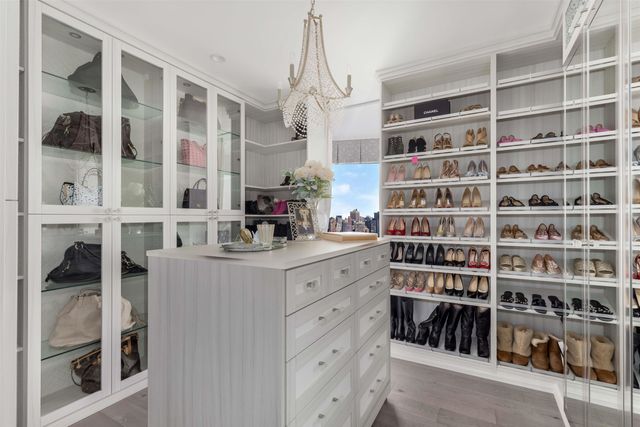 a large bed sitting in a bedroom next to a window and a larger closet