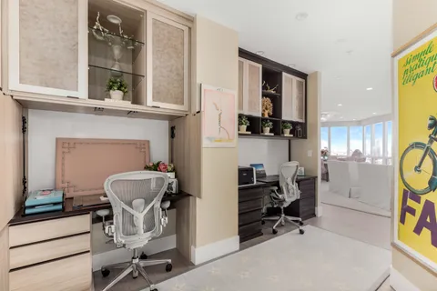 a living room with furniture and a ceiling fan