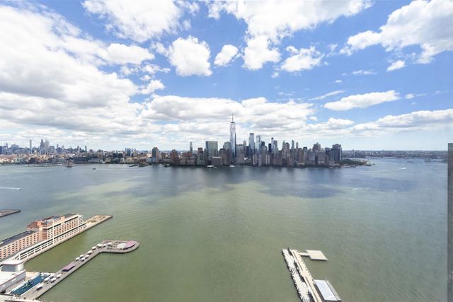 a dining room with furniture and a floor to ceiling window