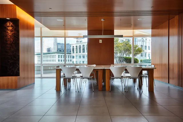 a living room filled with furniture windows and a floor to ceiling window