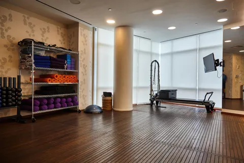 a living room with furniture and a floor to ceiling window