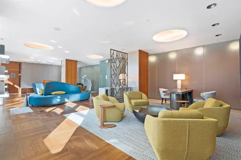 a lobby with furniture and stairs