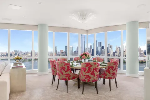 a dining room with furniture a rug and a chandelier