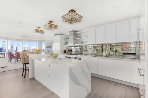 a large bed sitting in a bedroom next to a window