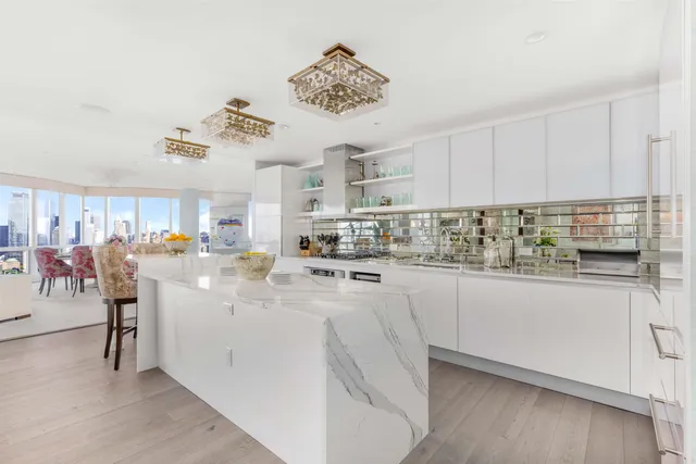 a large bed sitting in a bedroom next to a window