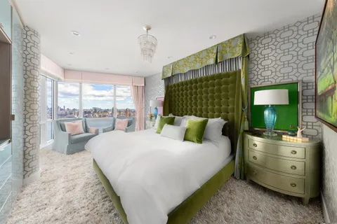 a living room with furniture a large window and a fireplace