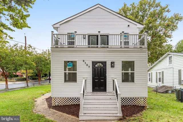 a view of a white house with a yard
