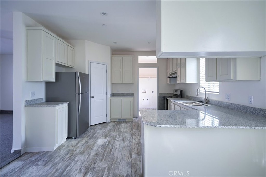 12012 Lager Road Phelan, CA 92371 - Photo 11 of 35 a kitchen with refrigerator and cabinets