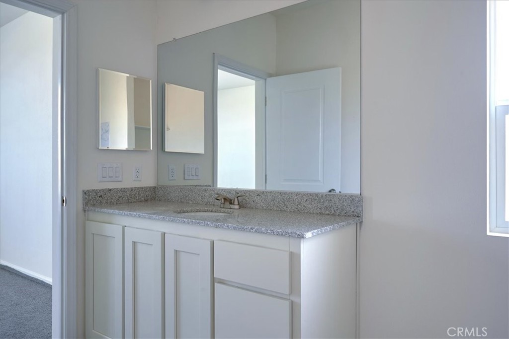 12012 Lager Road Phelan, CA 92371 - Photo 20 of 35 a bathroom with a granite countertop sink and a mirror