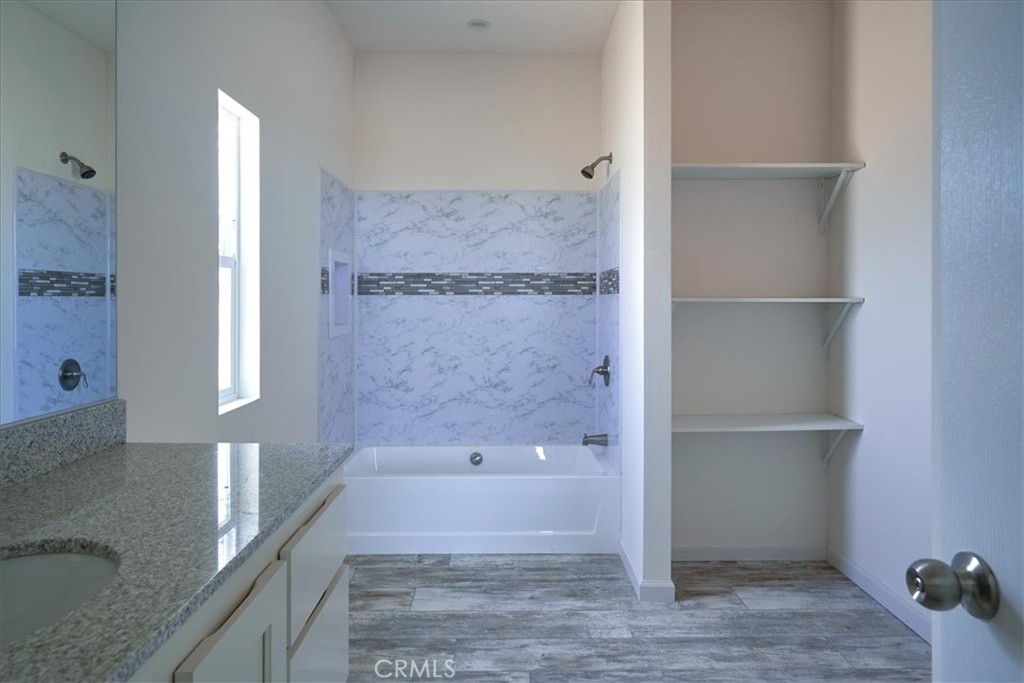 12012 Lager Road Phelan, CA 92371 - Photo 21 of 35 a bathroom with a bathtub and a shower