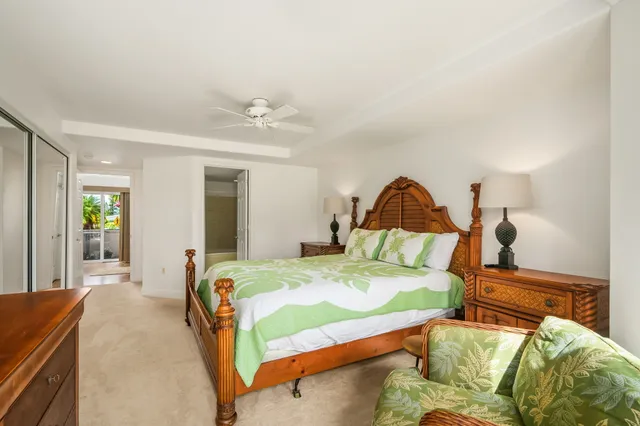 a bedroom with a bed a couch and dresser