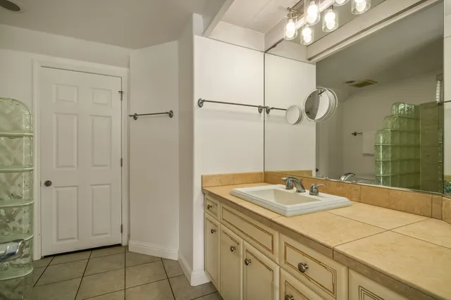 a bathroom with a sink vanity and a mirror