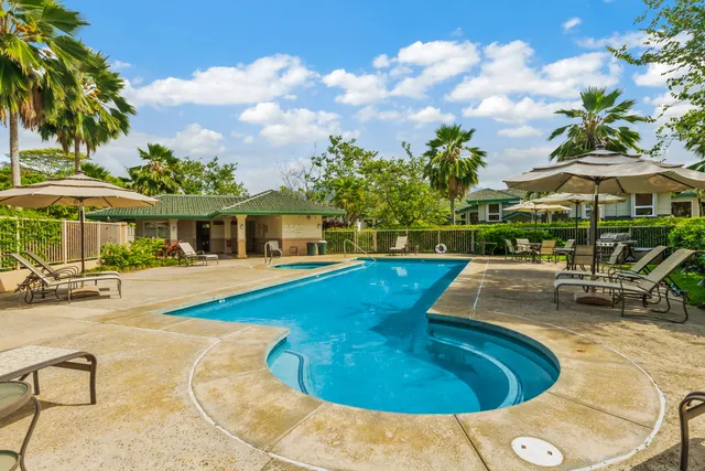 a view of a house with swimming pool and sitting area