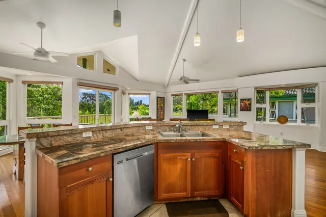 a kitchen with granite countertop a sink and a stove