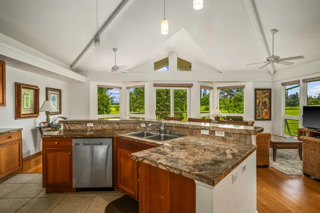 a kitchen with granite countertop kitchen island and windows
