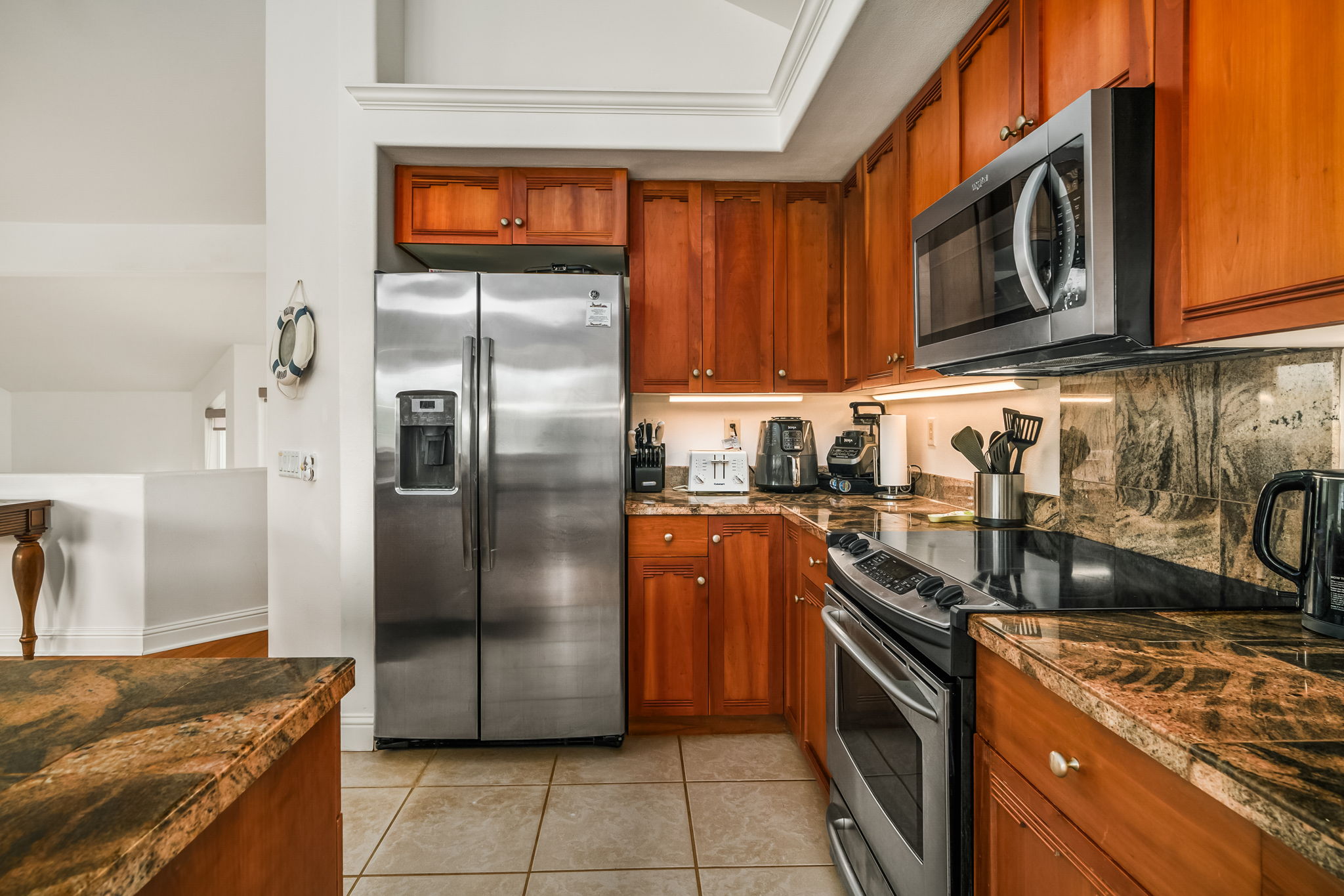 4141 Lei O Papa Road, Unit 6 Princeville, HI 96722 - Photo 5 of 26 a kitchen with stainless steel appliances granite countertop a refrigerator a stove and a sink