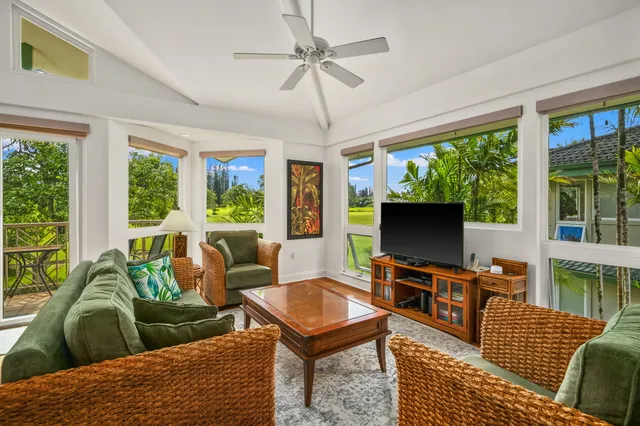 a living room with furniture a large window and a flat screen tv