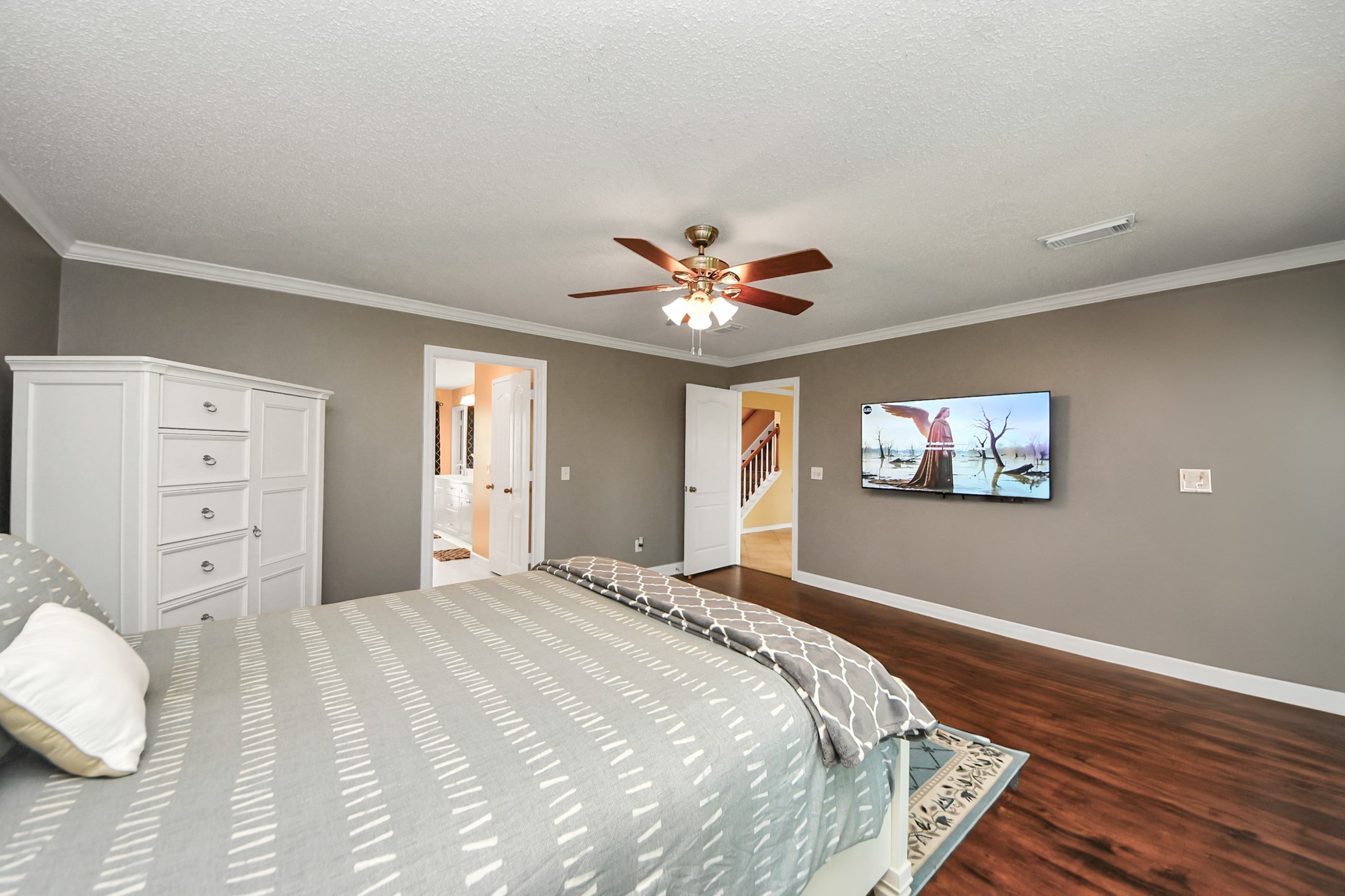 3107 Dulaney Road Houston, TX 77084 - Photo 19 of 50 a bedroom with a bed and a chandelier