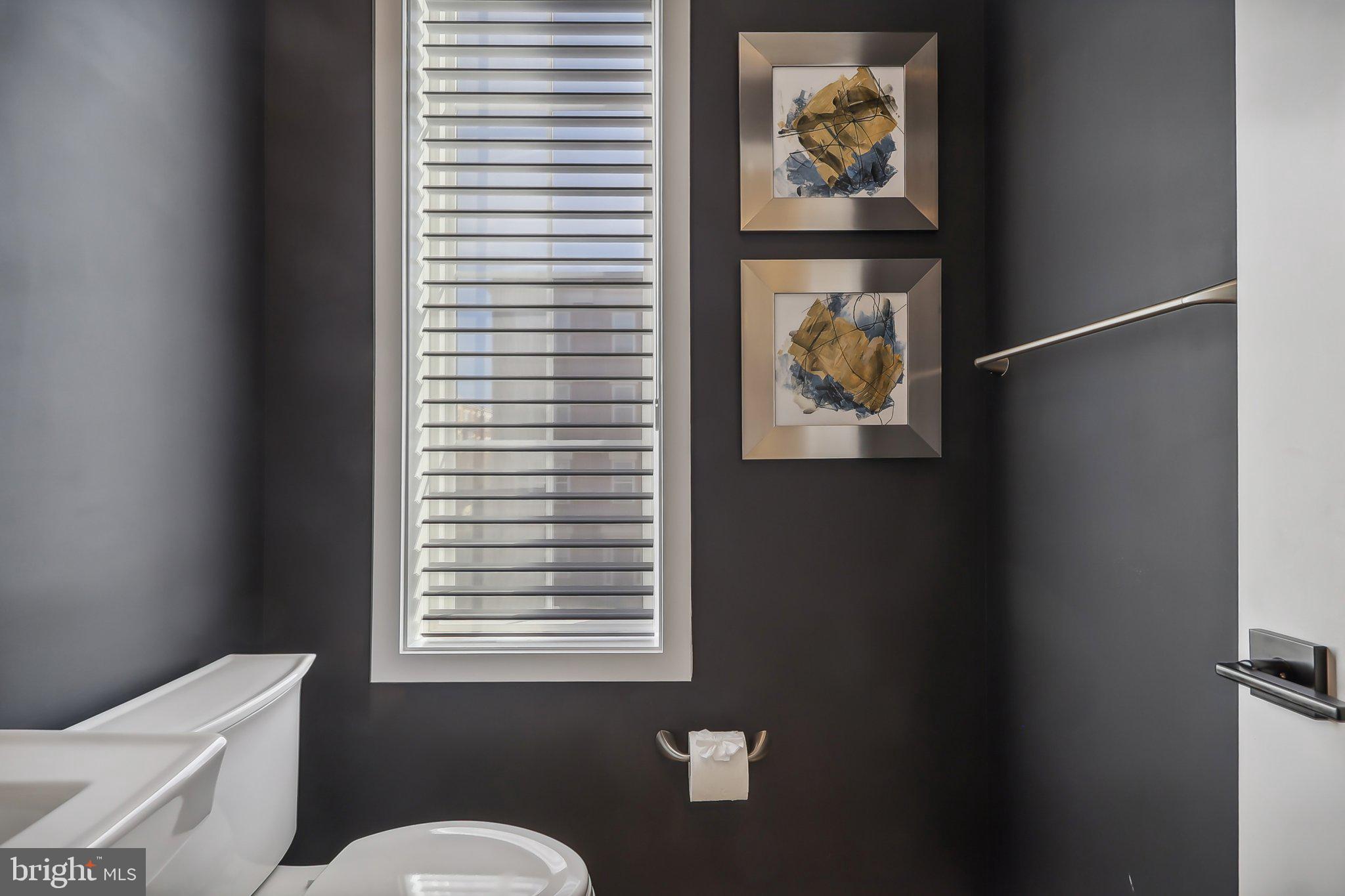 1970 Roland Clarke Place Reston, VA 20191 - Photo 28 of 72 a bathroom with a painting on the wall and a window