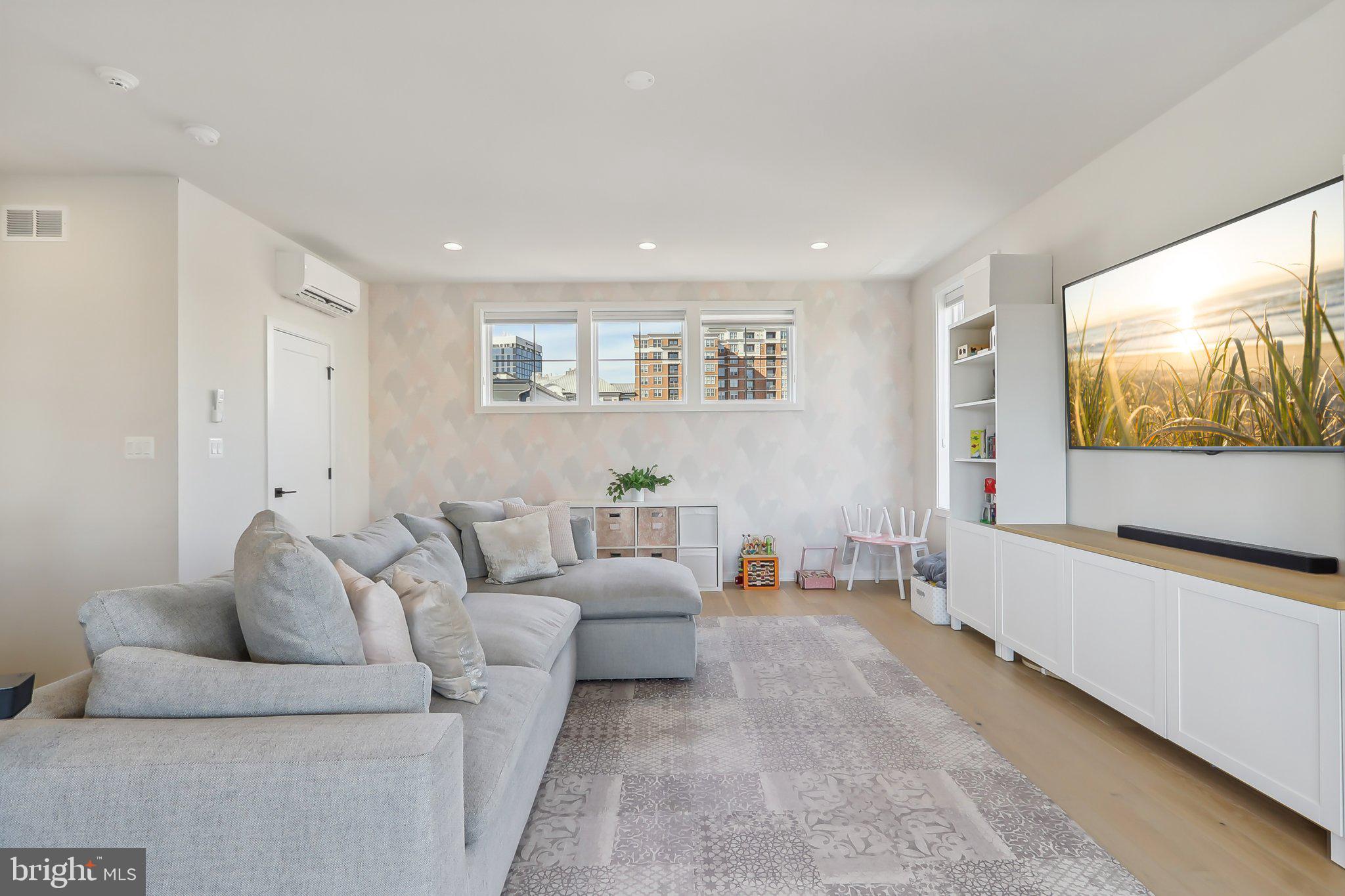 1970 Roland Clarke Place Reston, VA 20191 - Photo 50 of 72 a living room with furniture and a flat screen tv