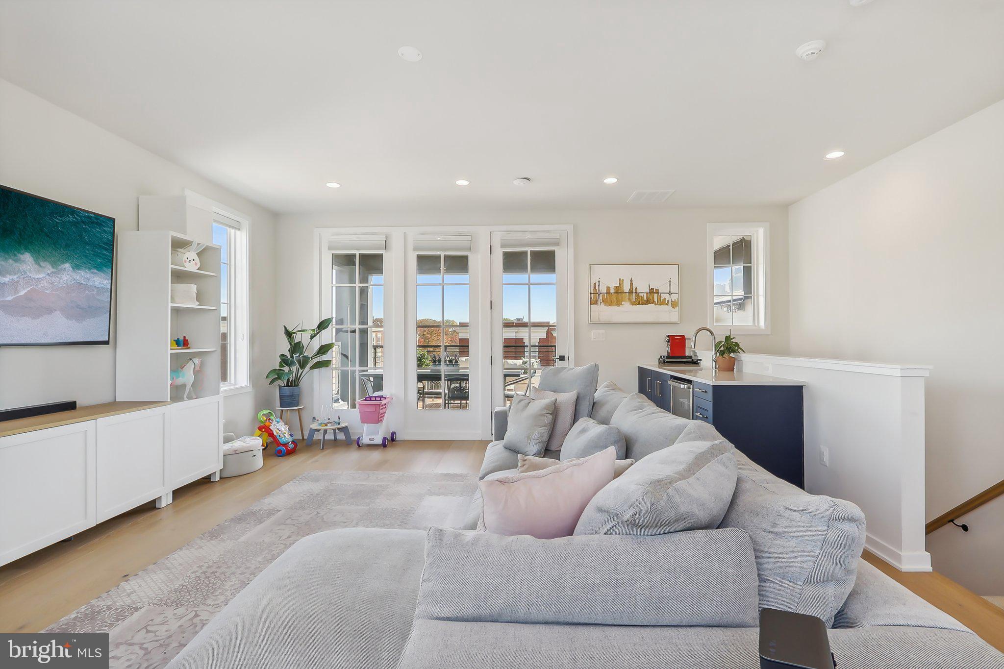 1970 Roland Clarke Place Reston, VA 20191 - Photo 53 of 72 a living room with furniture and a flat screen tv